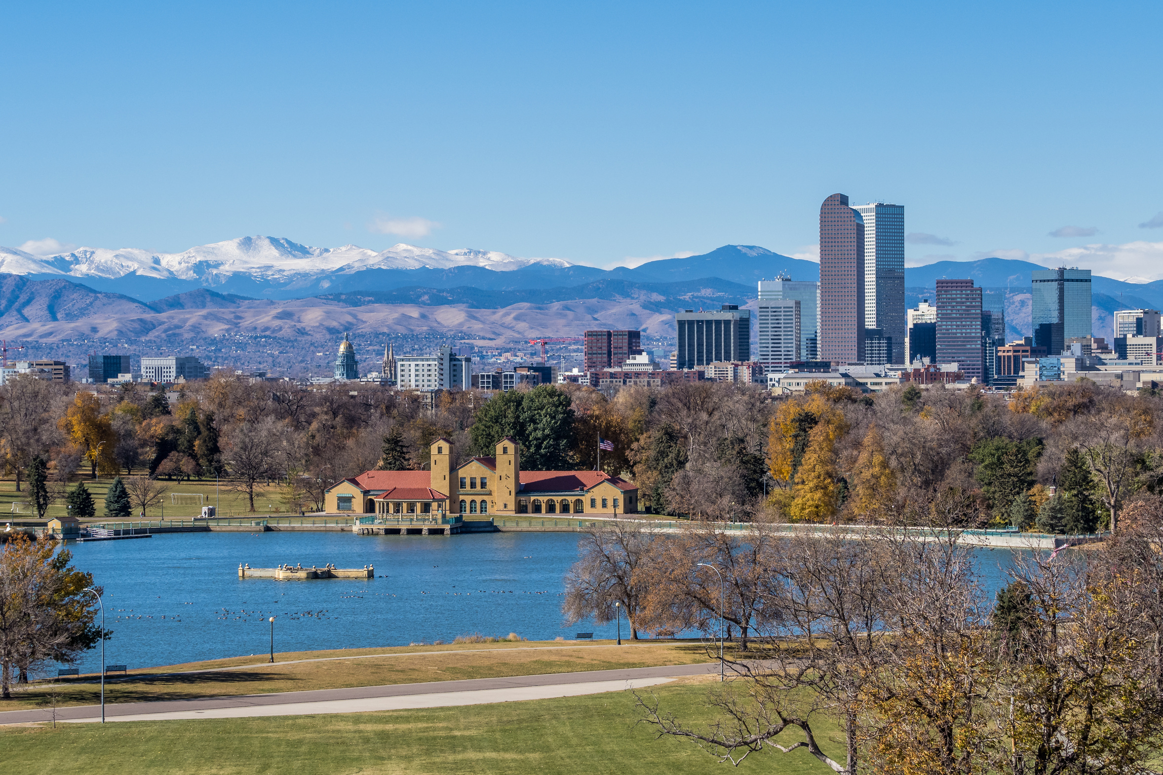 The Denver skyline and mountains seen across the lake at City Park